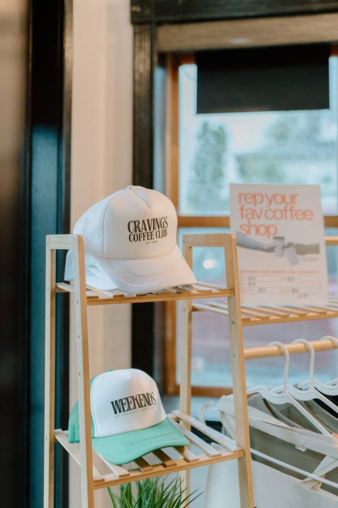 white and green hats that are available to purchase at a coffee shop