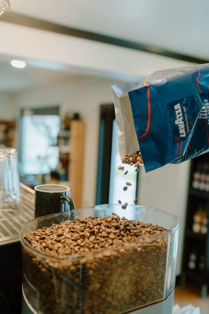 espresso beans being pored into coffee machine