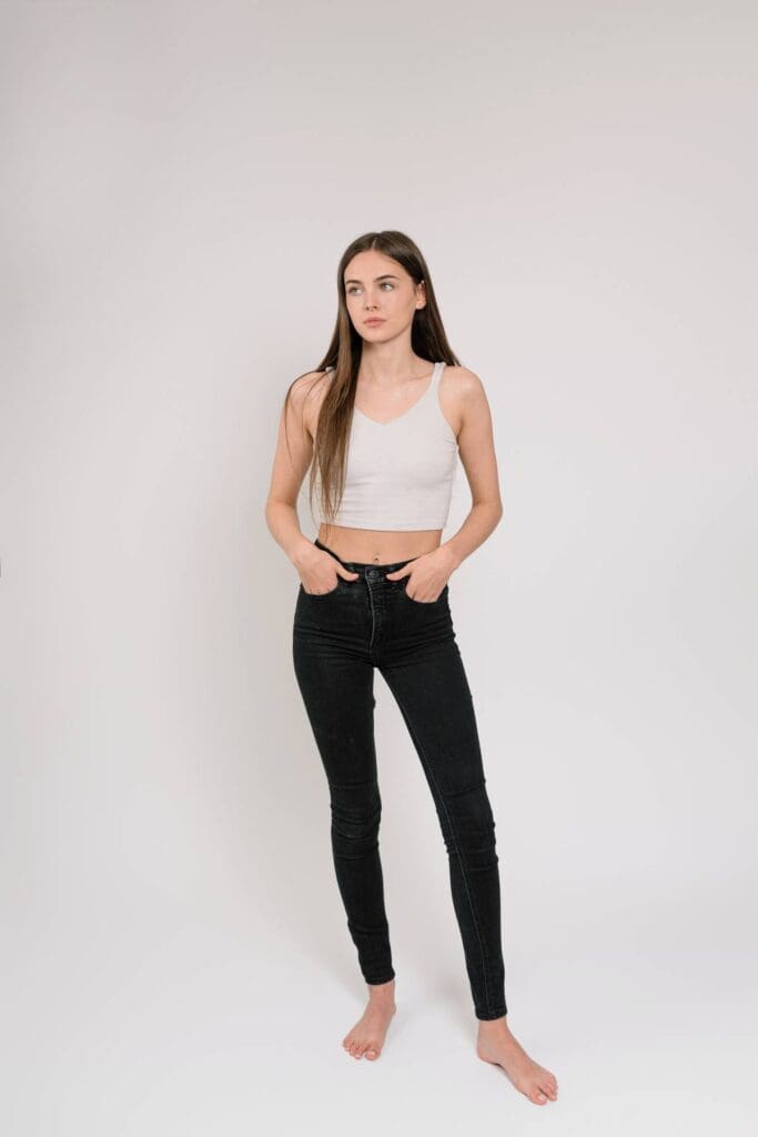 Full-body studio shot in jeans and a casual top, highlighting a laid-back and approachable look, perfect for lifestyle modeling.