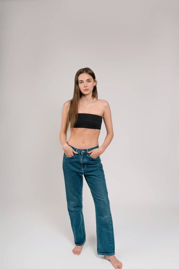 Full-body look with jeans and a simple black top, perfect for a relaxed and approachable modeling portfolio.