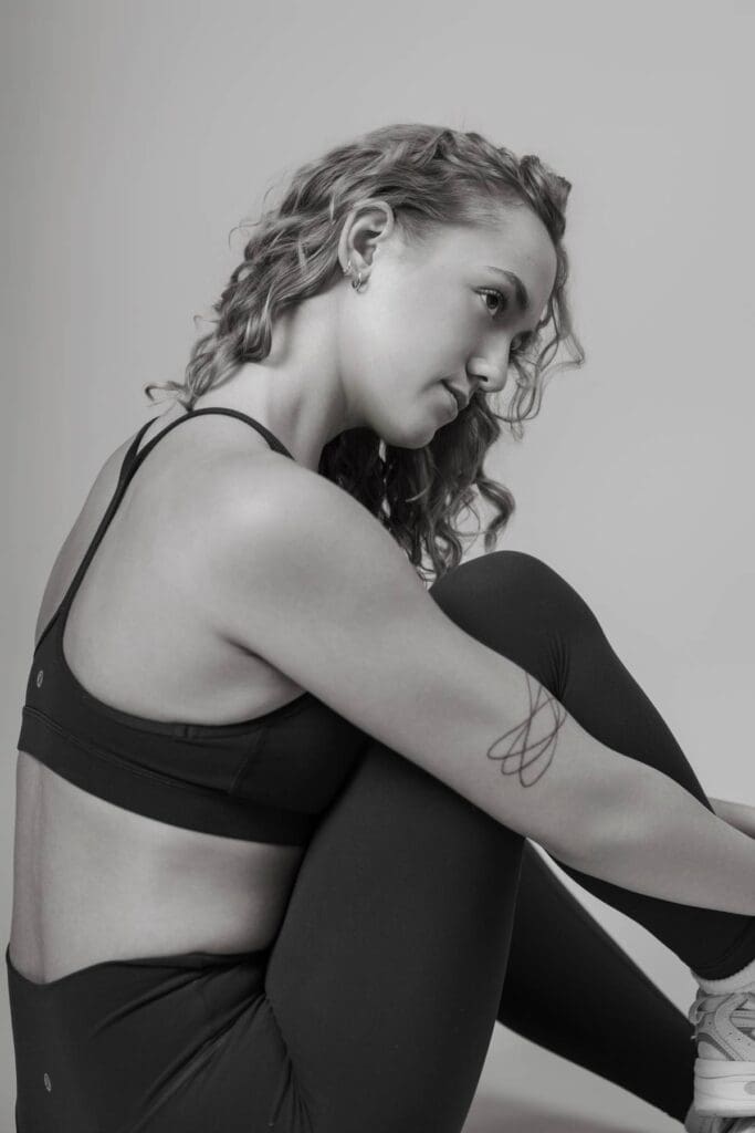 Headshot of lifestyle coach smiling at me during a studio setup wearing workout clothes