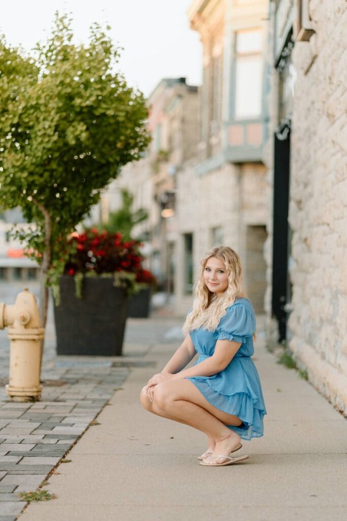 Kalea sitting at an outdoor patio in Milwaukee, showcasing a casual, urban vibe.