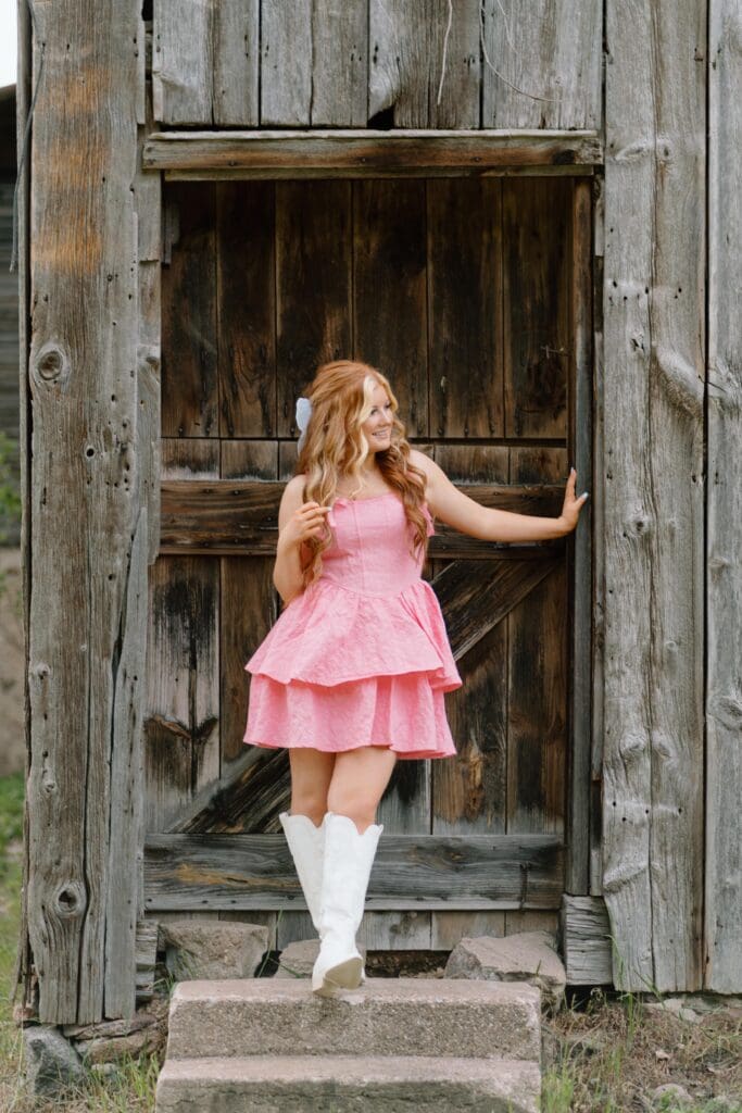 Full-body senior portrait with wild grasses and golden light