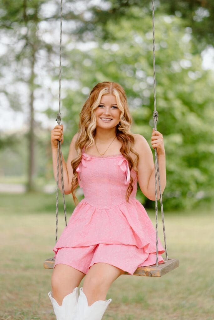 Golden hour senior portrait in a Wisconsin field with soft sunset lighting